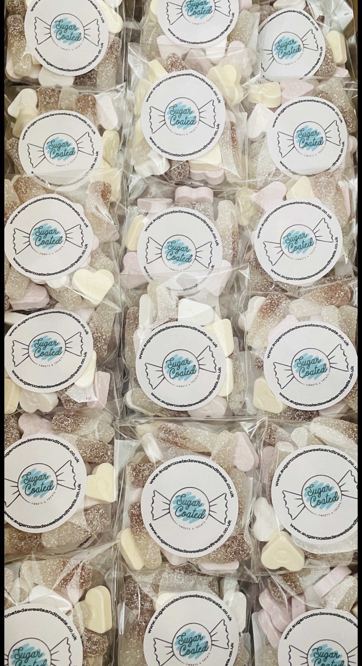 A bunch of marshmallows in plastic containers with labels on them.