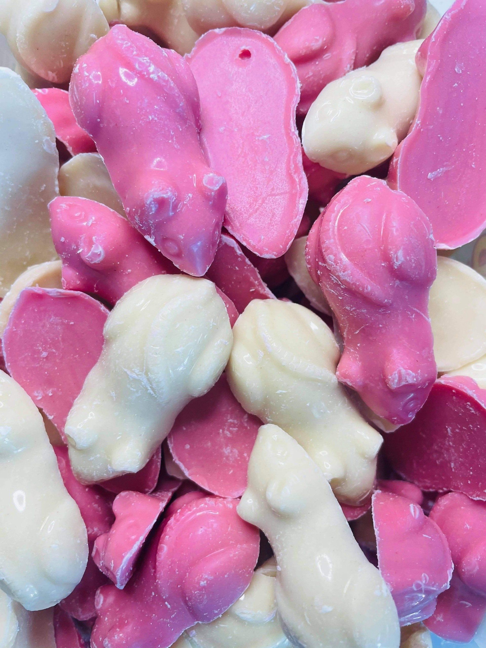 A pile of pink and white candy in the shape of mice