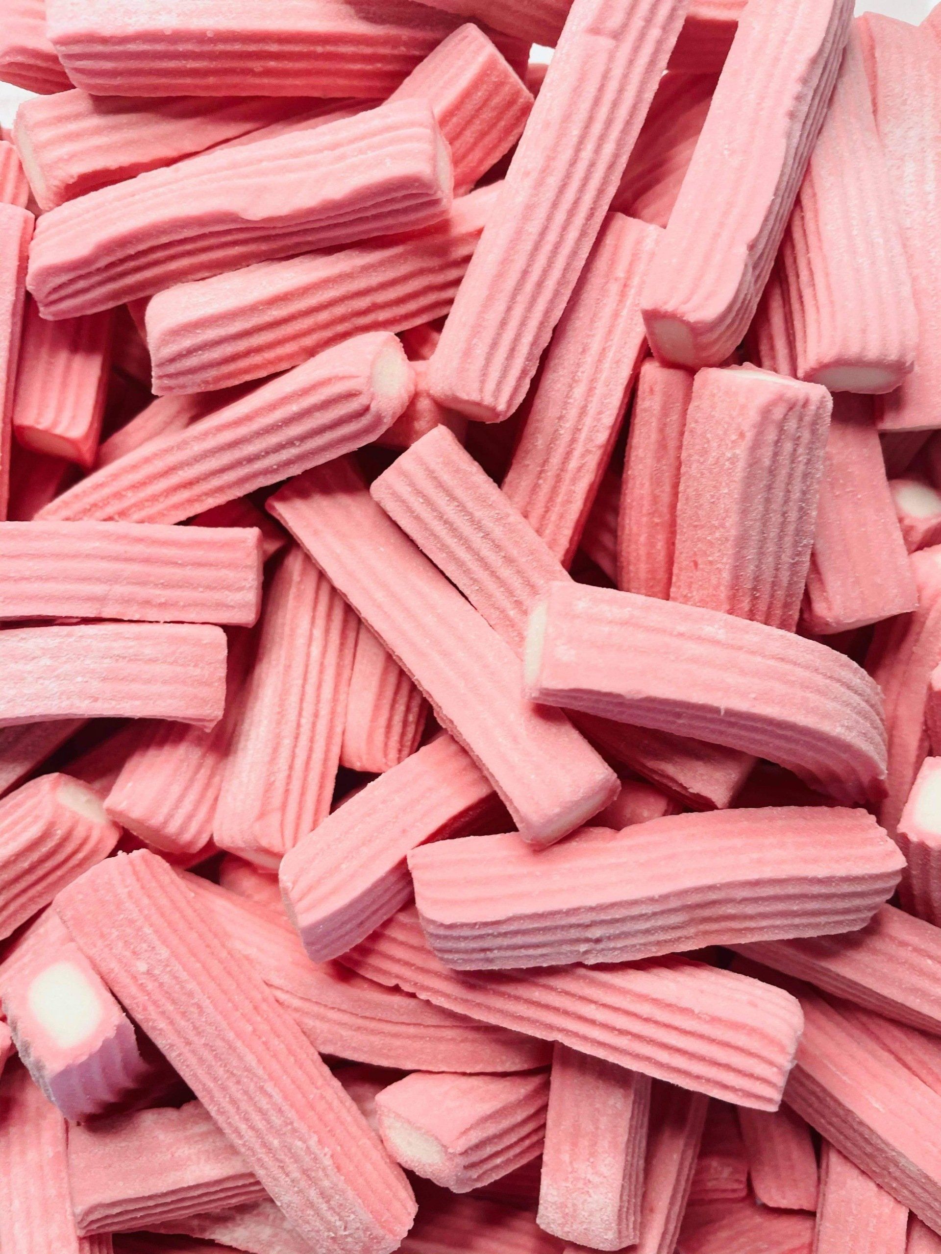 A pile of pink sticks stacked on top of each other