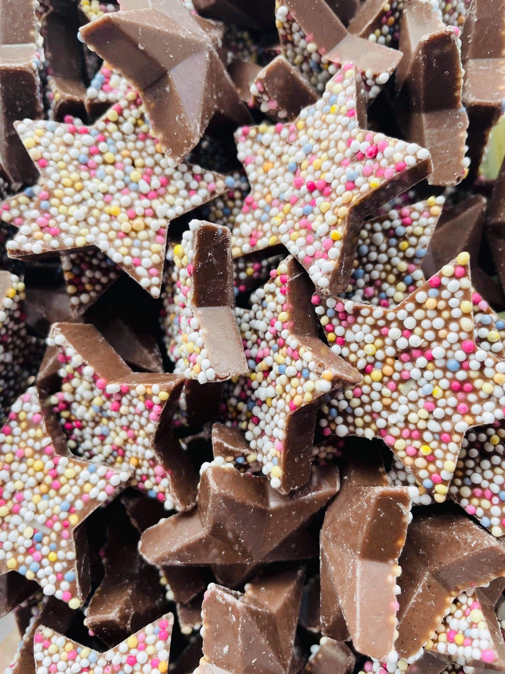 A pile of chocolate stars with sprinkles on them