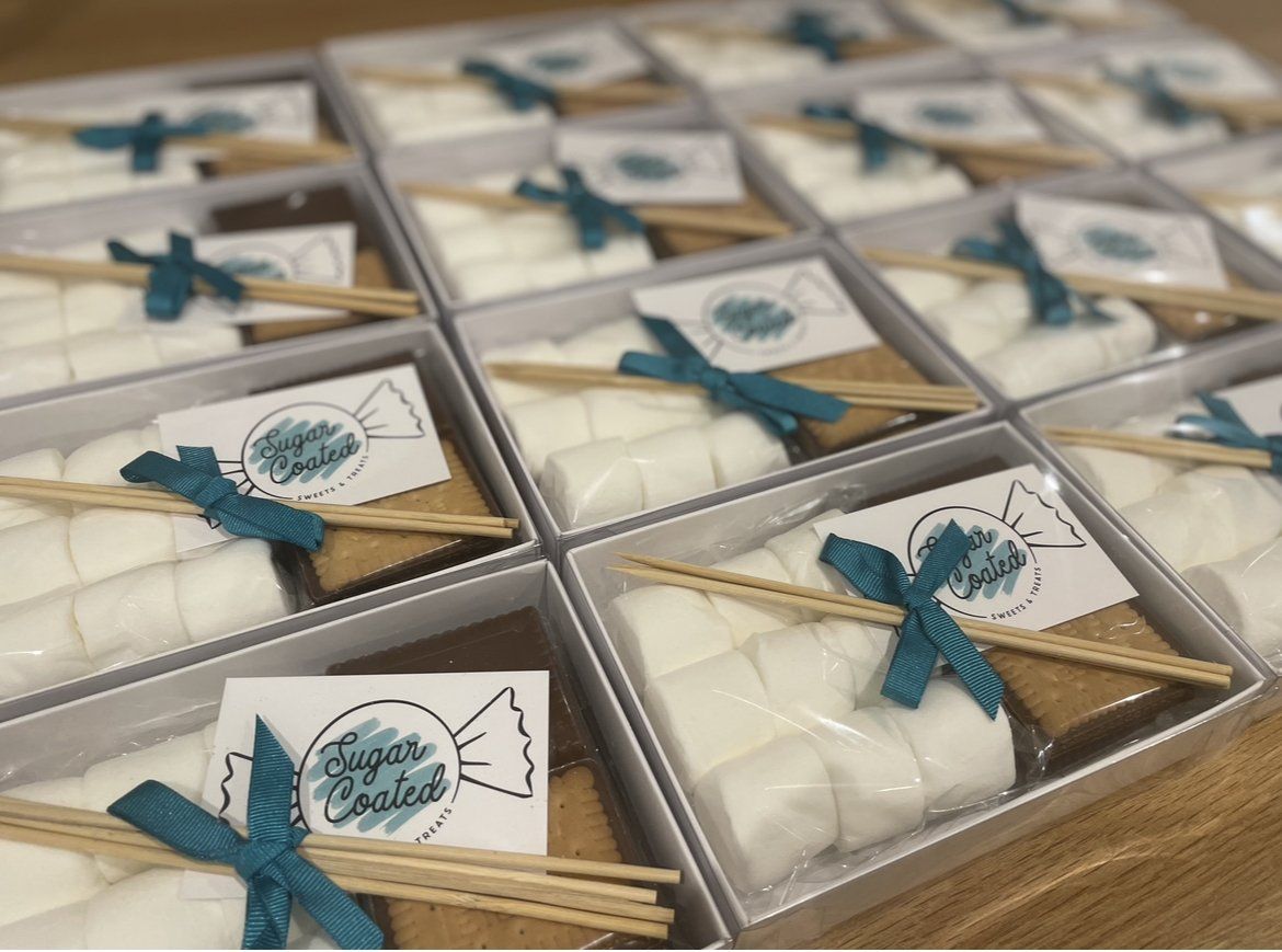 A bunch of boxes filled with s'mores and marshmallows