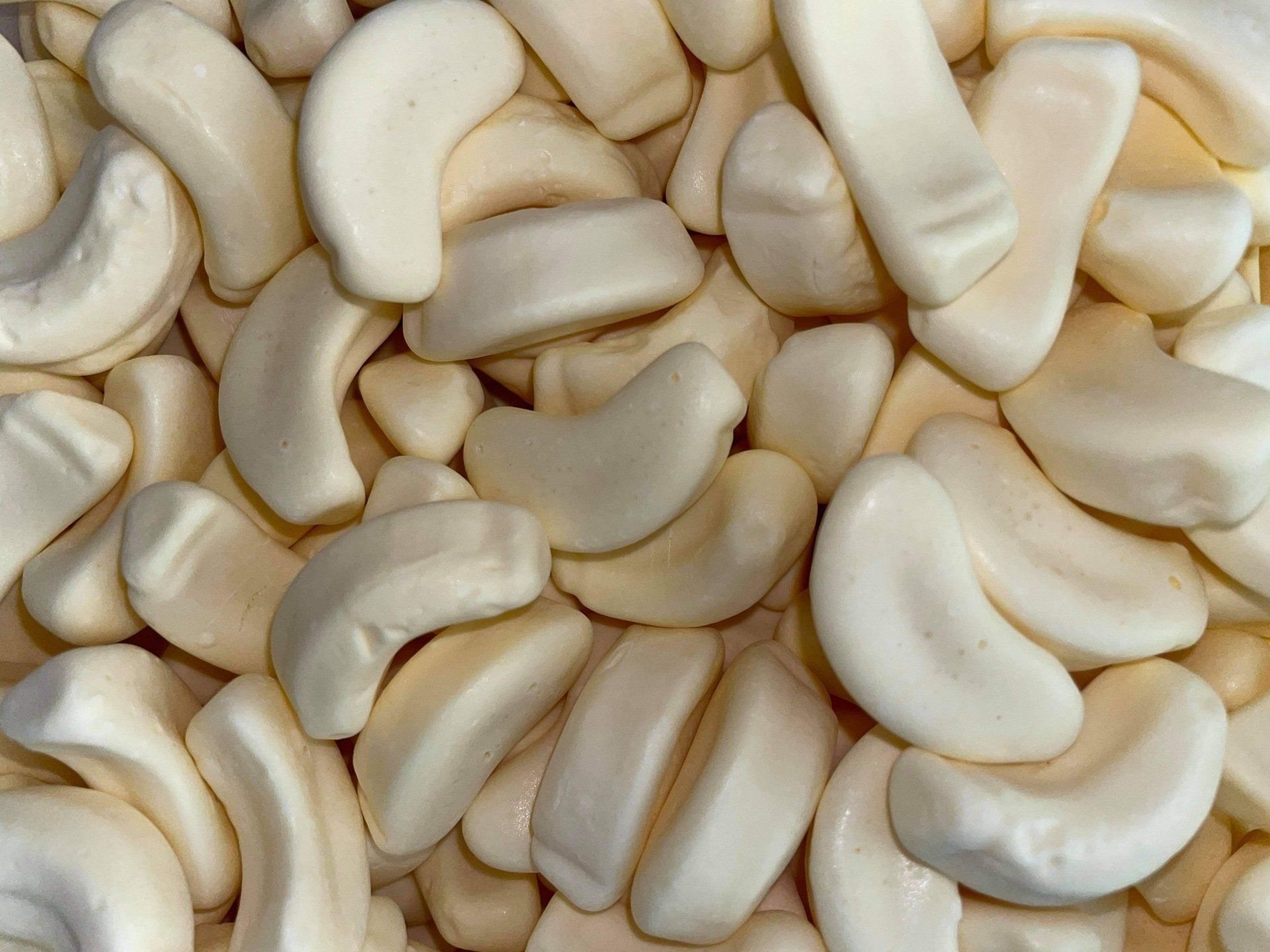 A pile of white candy in the shape of bananas
