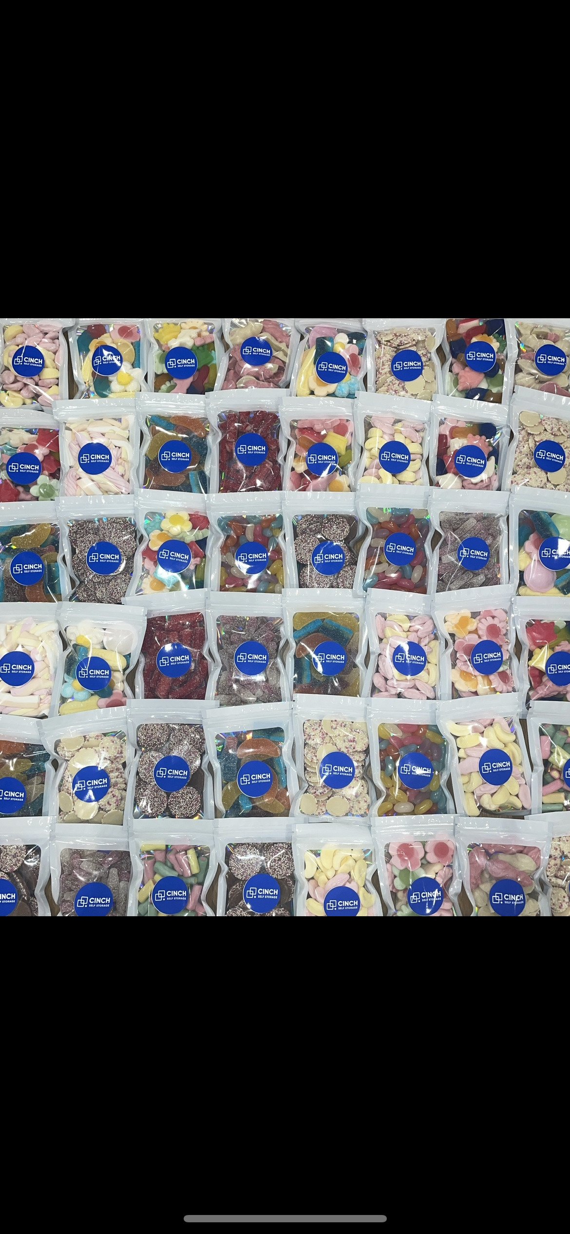 A bunch of bags of candy are sitting on top of each other on a table.