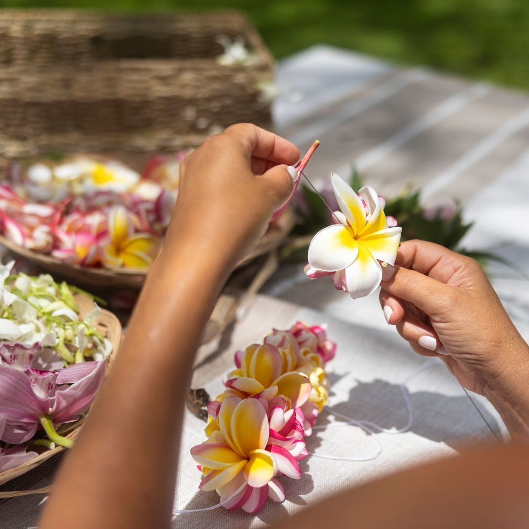a person is holding a flower with a yellow center