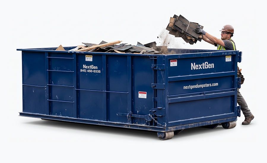 Worker loading debris into a blue dumpster