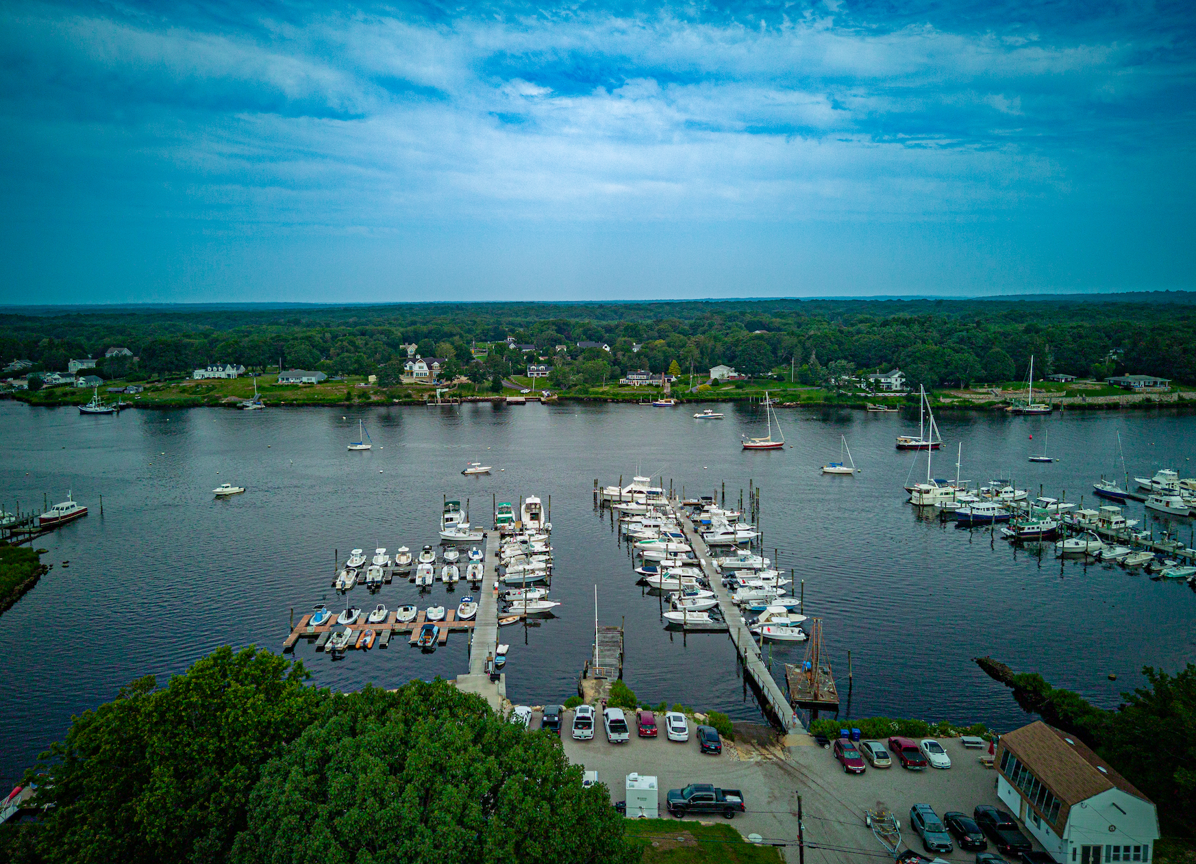 An aerial view of a marina with boats docked in the water.