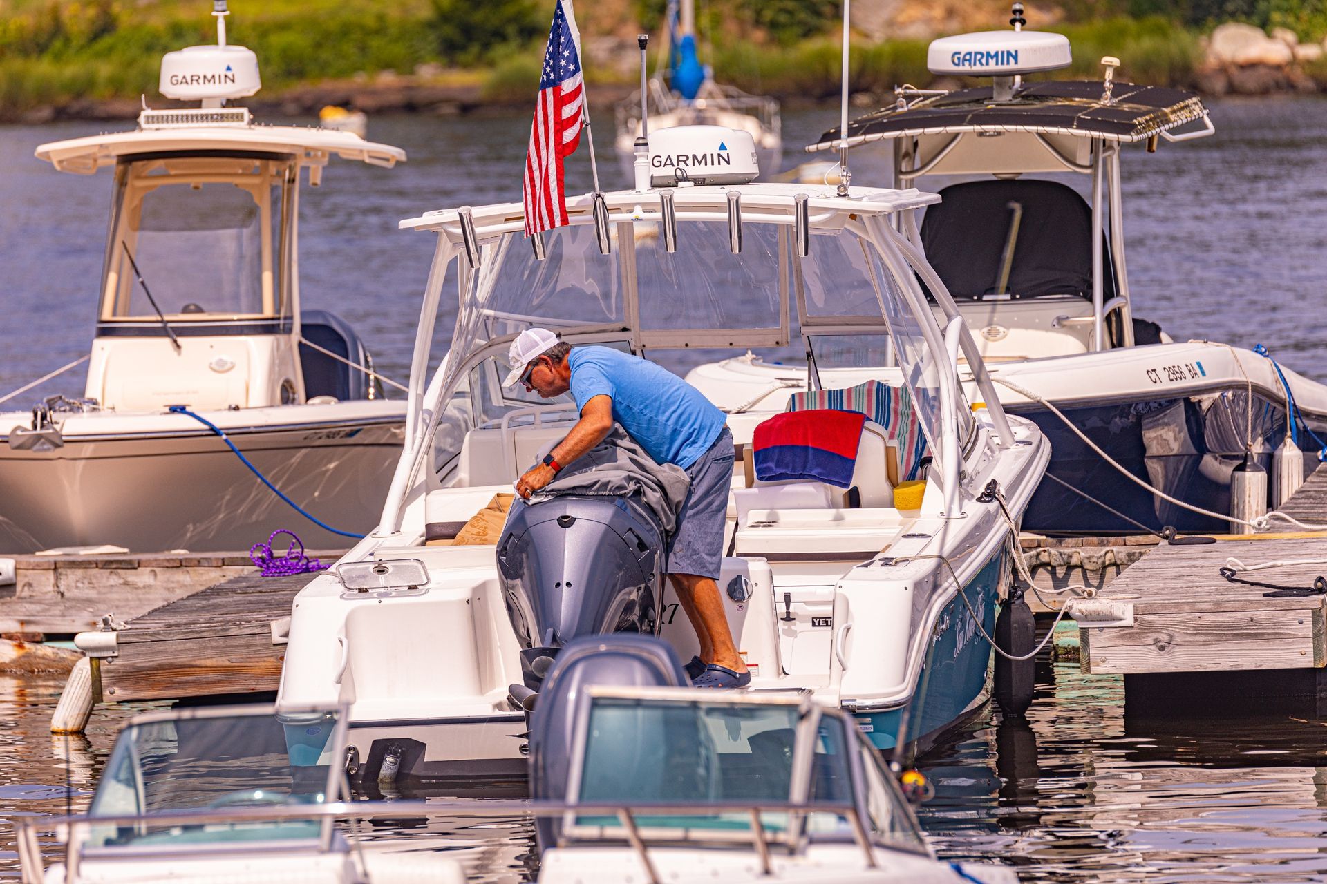 A man is working on the engine of a boat.