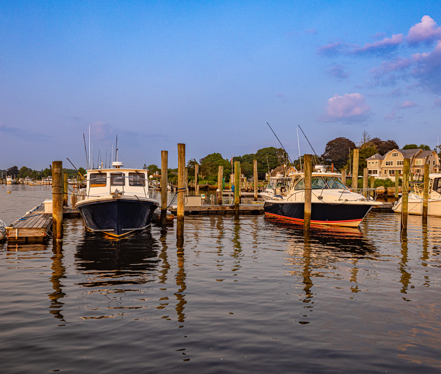 Two boats are docked at a dock in the water