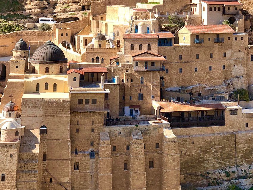 A group of buildings are sitting on top of a hill.