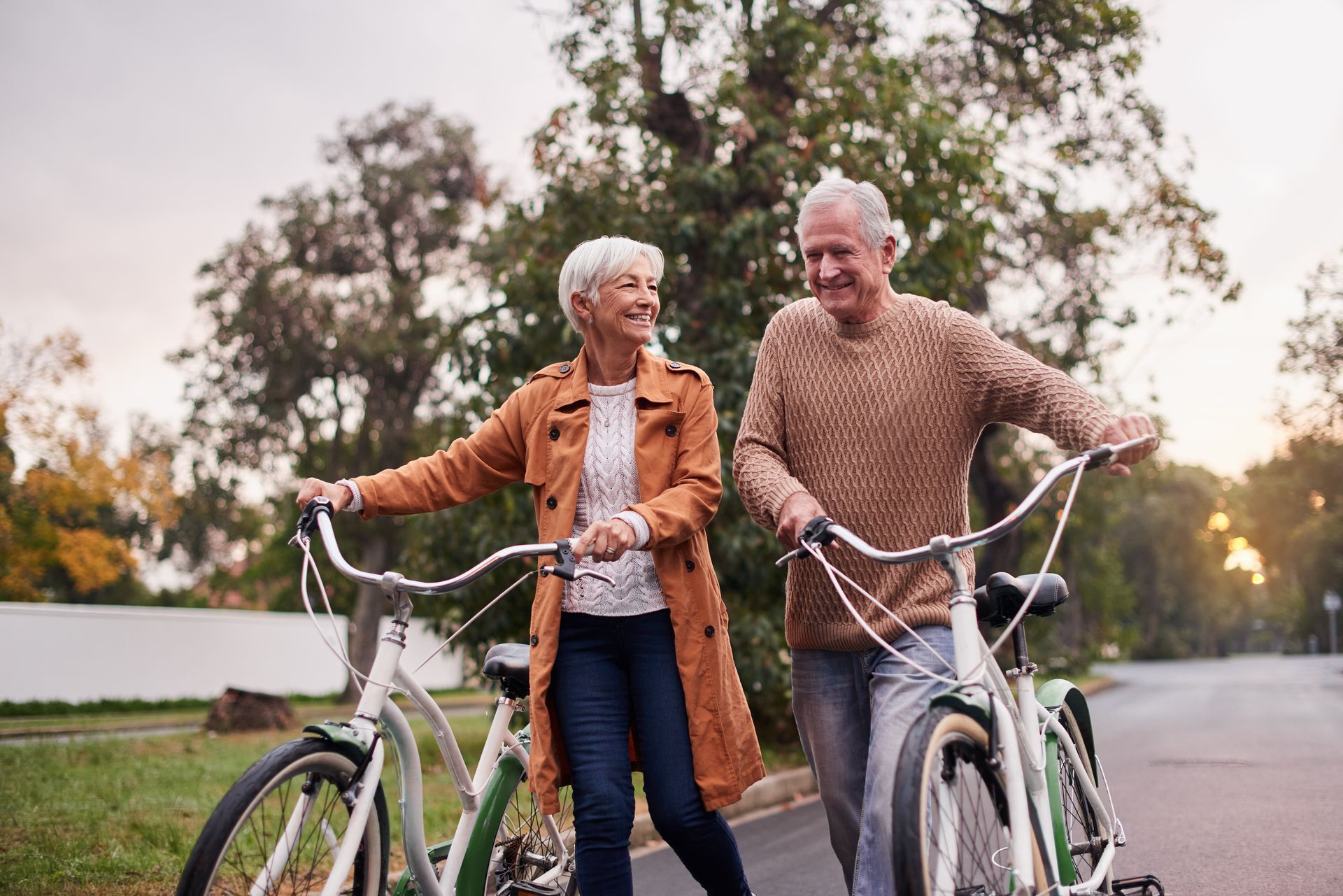 Retired couple out walking their bikes