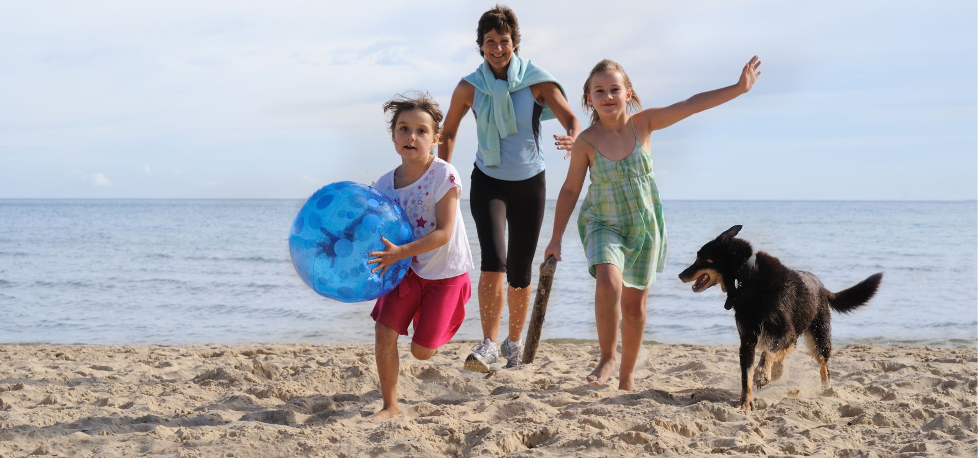 Family walking dog on Carolina Beach