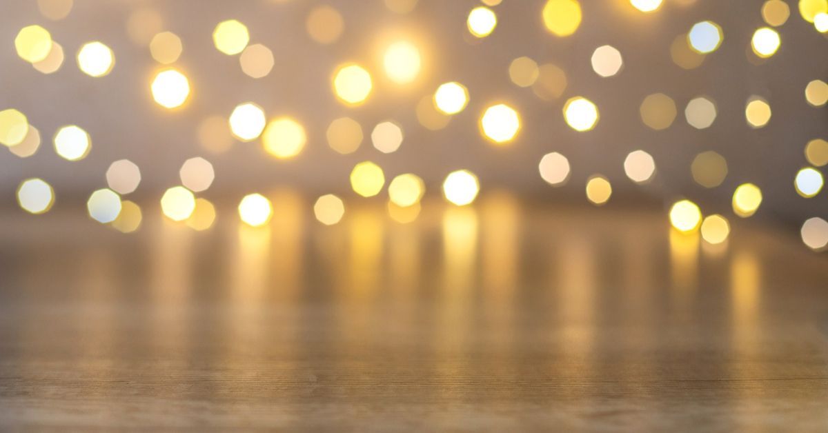 Golden holiday lights softly glowing against a blurred background, evoking the festive ambiance of Carolina Beach’s winter season.