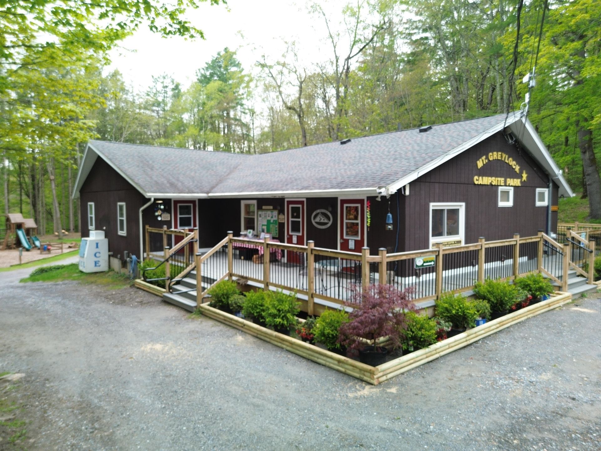 A campground activitiy center with a golf cart parked in front of it