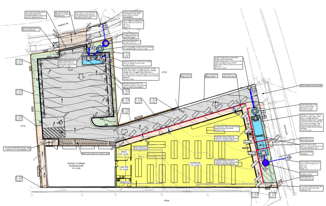 Site plan drawing with color-coded lots: gray, yellow, and narrow blue strip along a sloped boundary.
