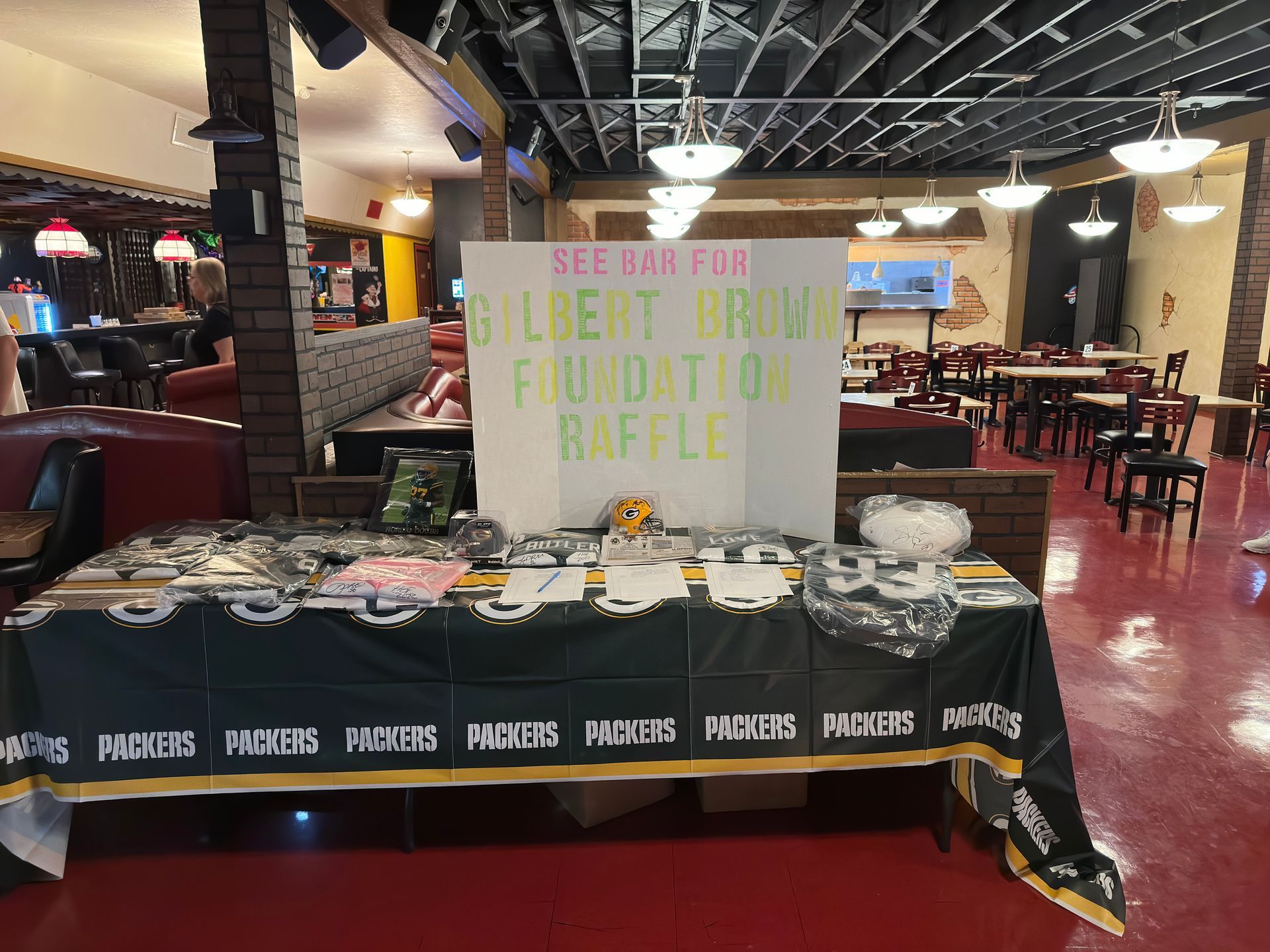 Table with Packers raffle items, sign saying 