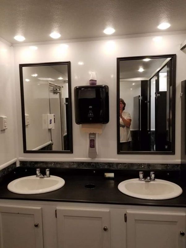 A bathroom with two sinks and two mirrors.