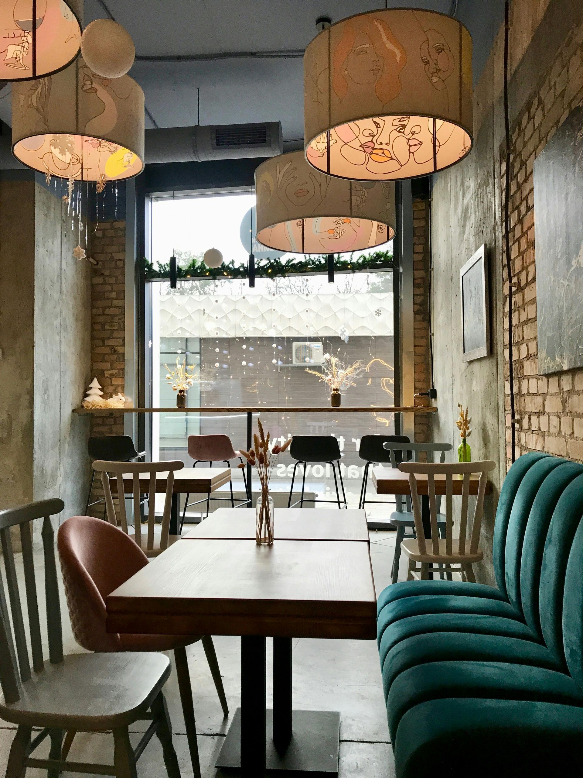 A restaurant with tables and chairs and a blue couch