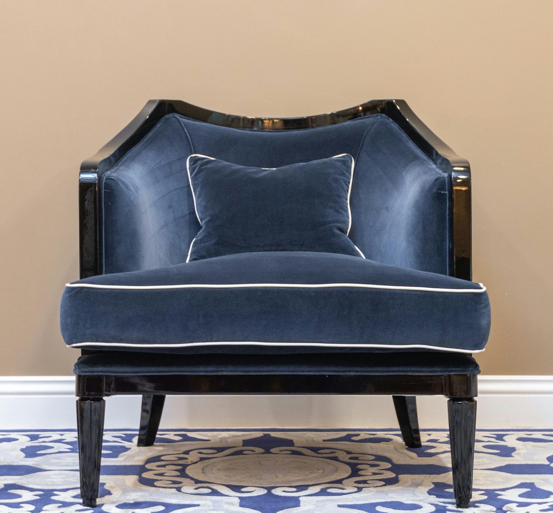 A blue chair with a white pillow on it