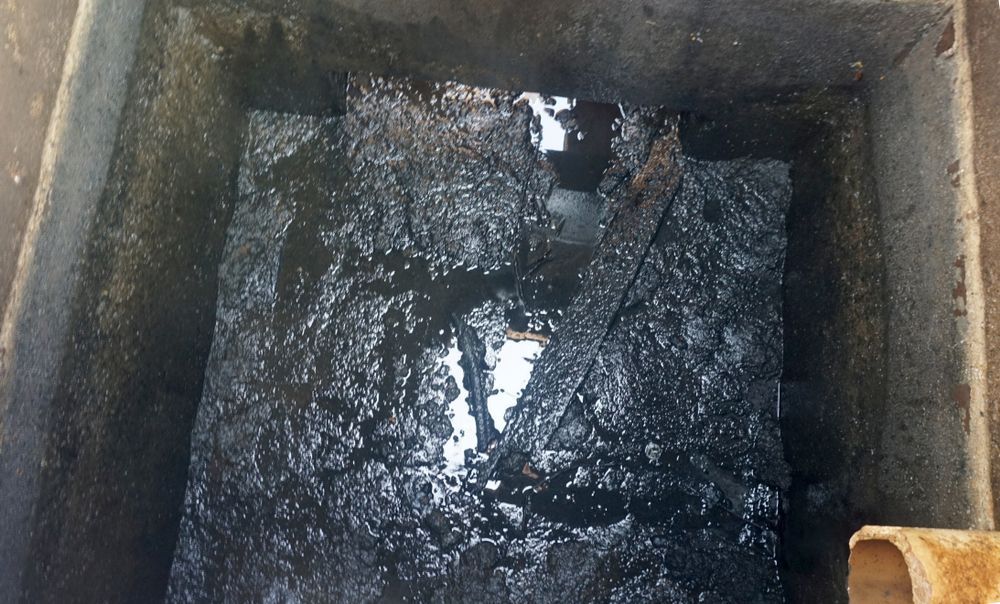 Murky Liquid Pooled Inside a Rectangular Concrete Pit or Tank — Tamworth Septic & Liquid Waste in Manilla & Barraba, NSW