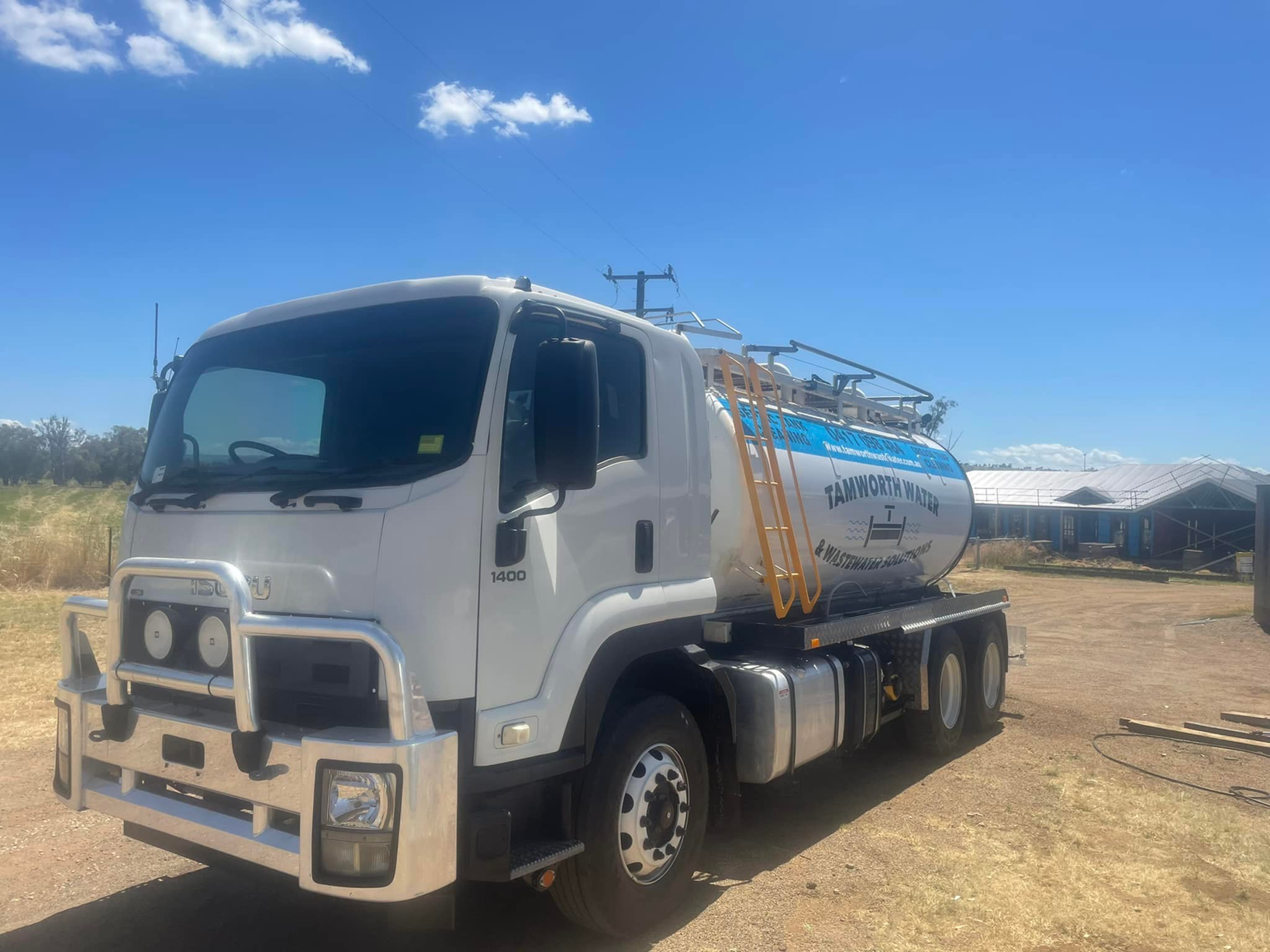 White Utility Truck with A Tank Trailer Parked on A Dirt Lot Under a Blue Sky — Tamworth Septic & Liquid Waste in Duri, NSW