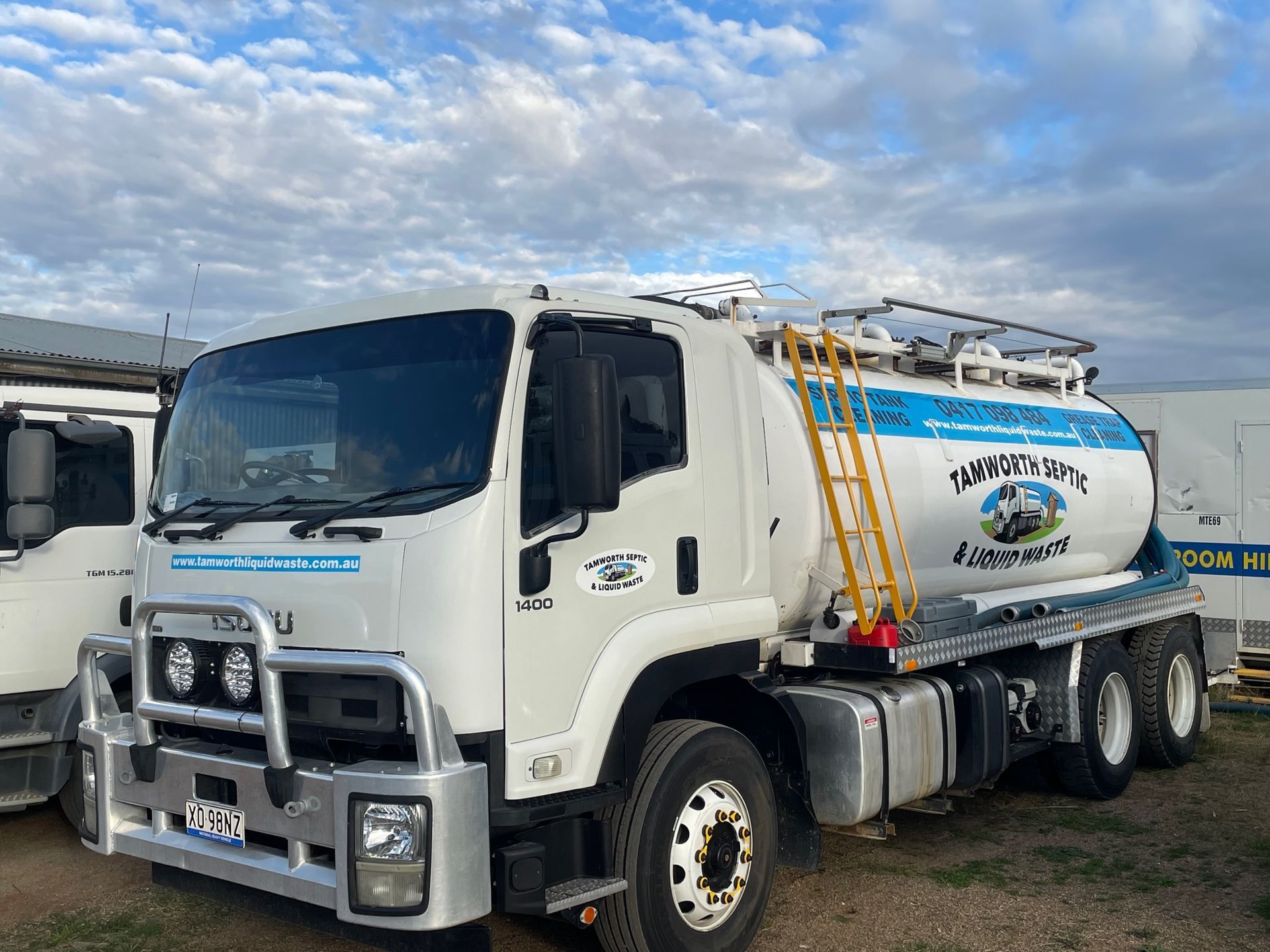 White Tanker Truck Parked on Gravel Under a Cloudy Sky — Tamworth Septic & Liquid Waste in Manilla & Barraba, NSW