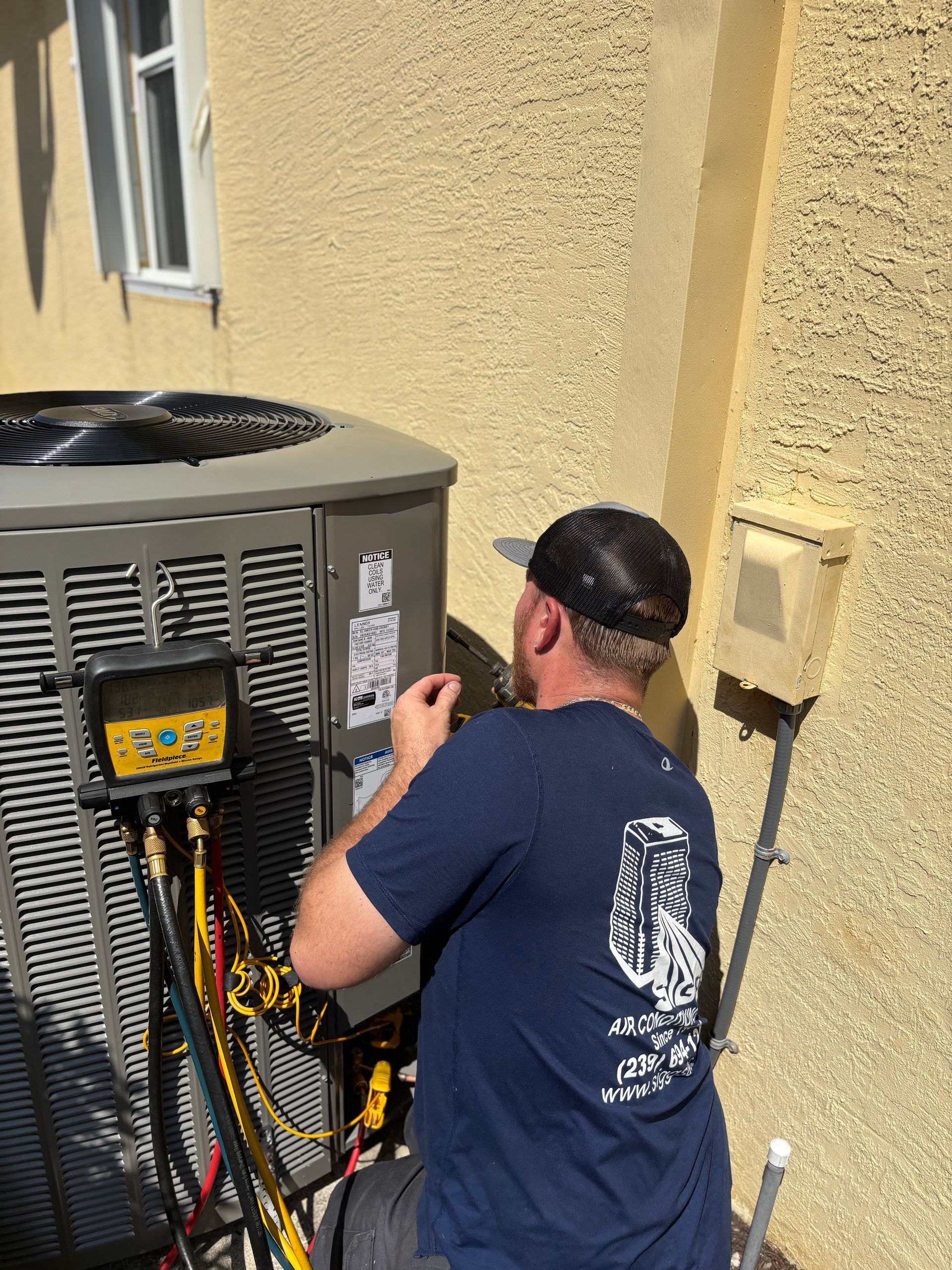 Siggs technician servicing outdoor AC unit CU
