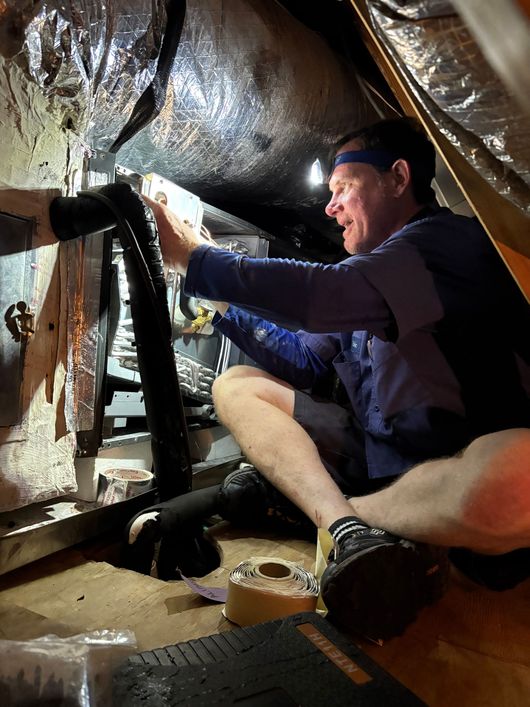 Siggs technician repairing AC