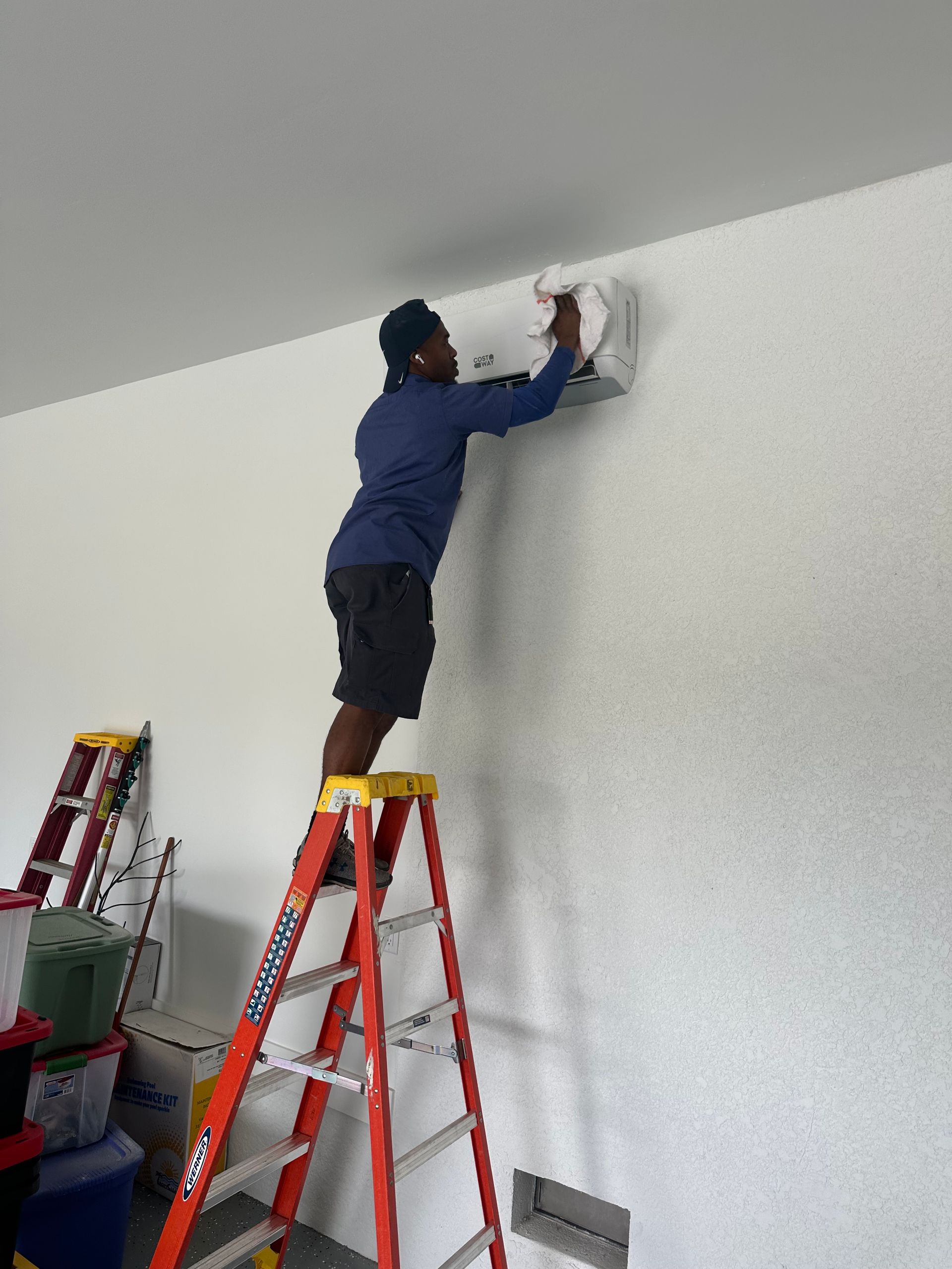 Siggs technician installing a garage mini split hvac system