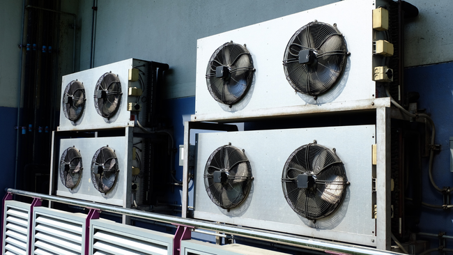 A bunch of fans are stacked on top of each other in a room.