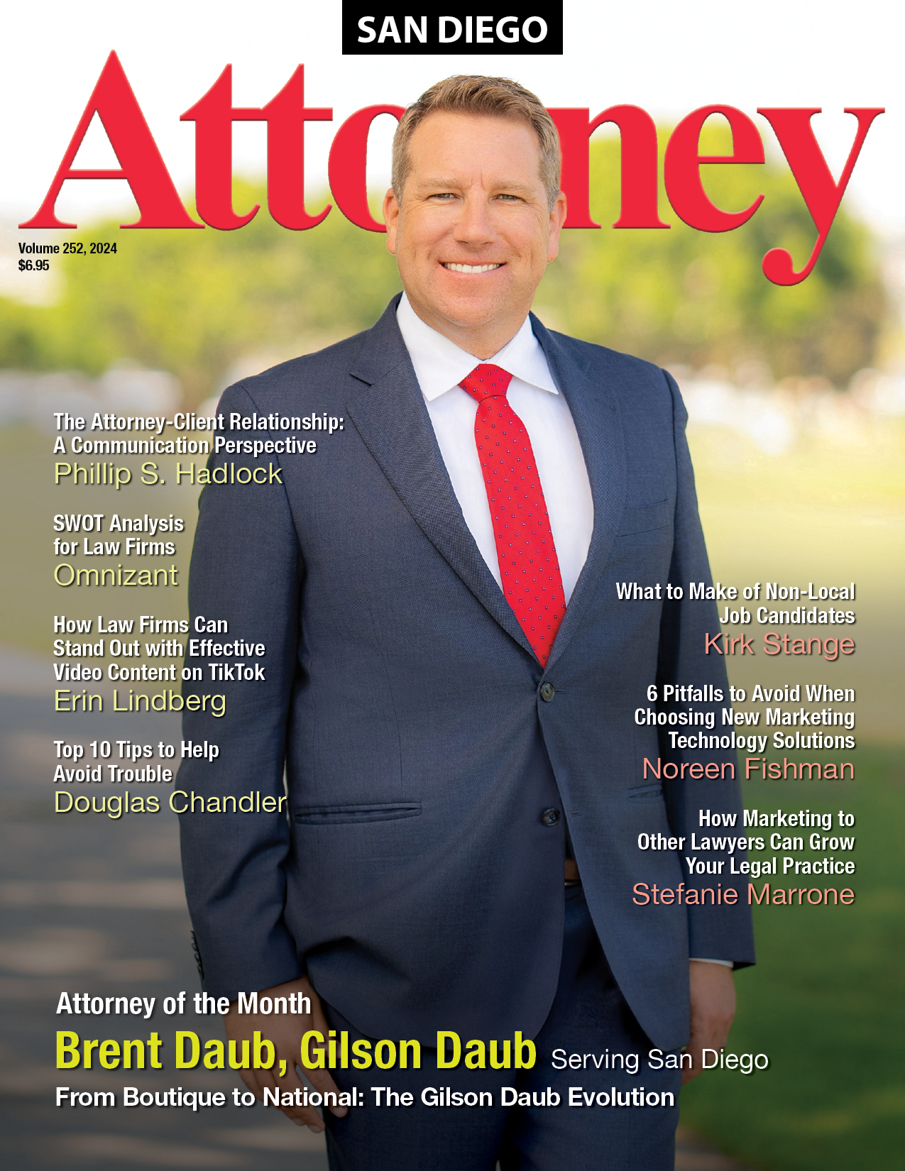 A man in a suit and red tie is on the cover of an orange county attorney magazine