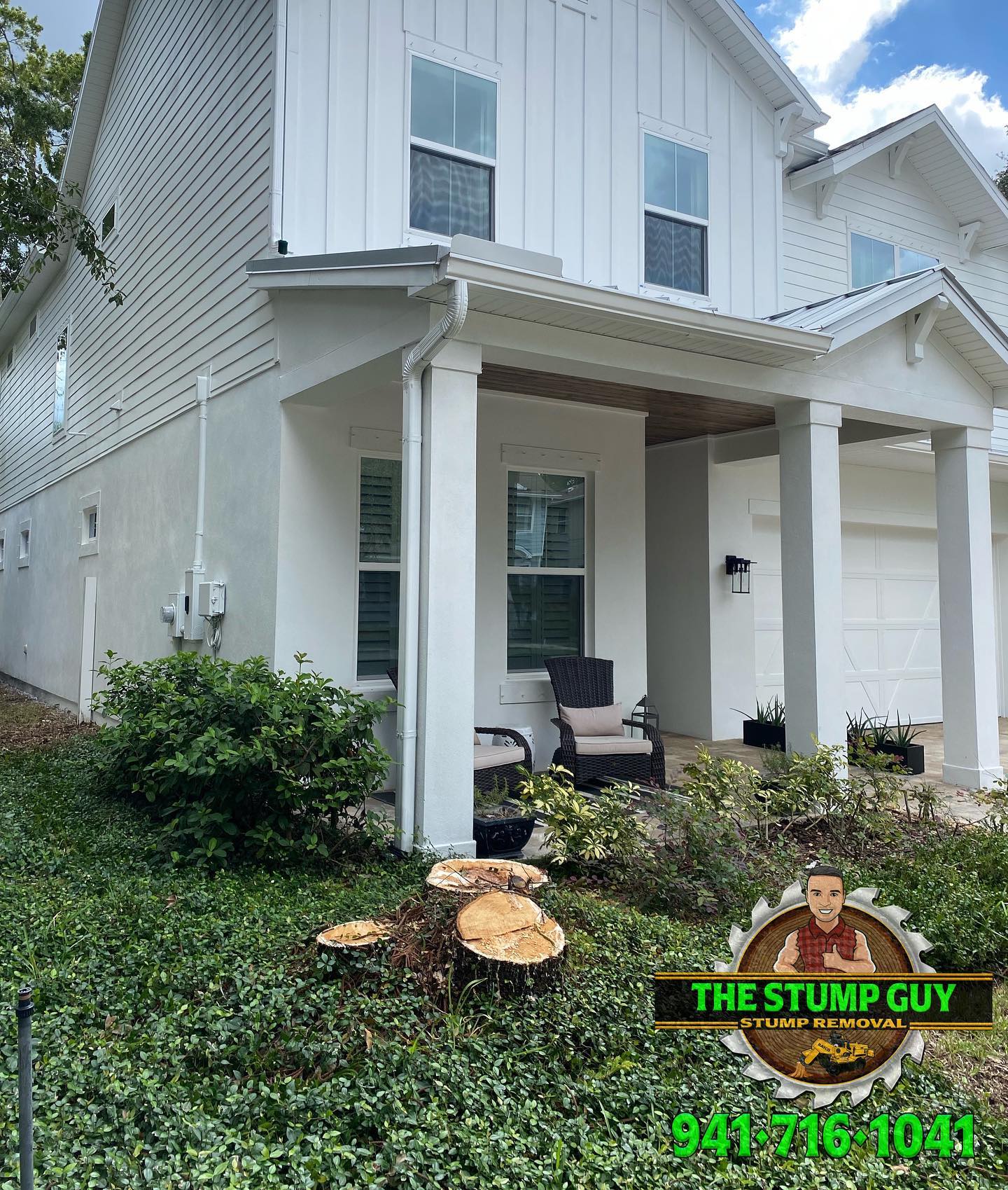 White house with a tree stump in front and a business logo.