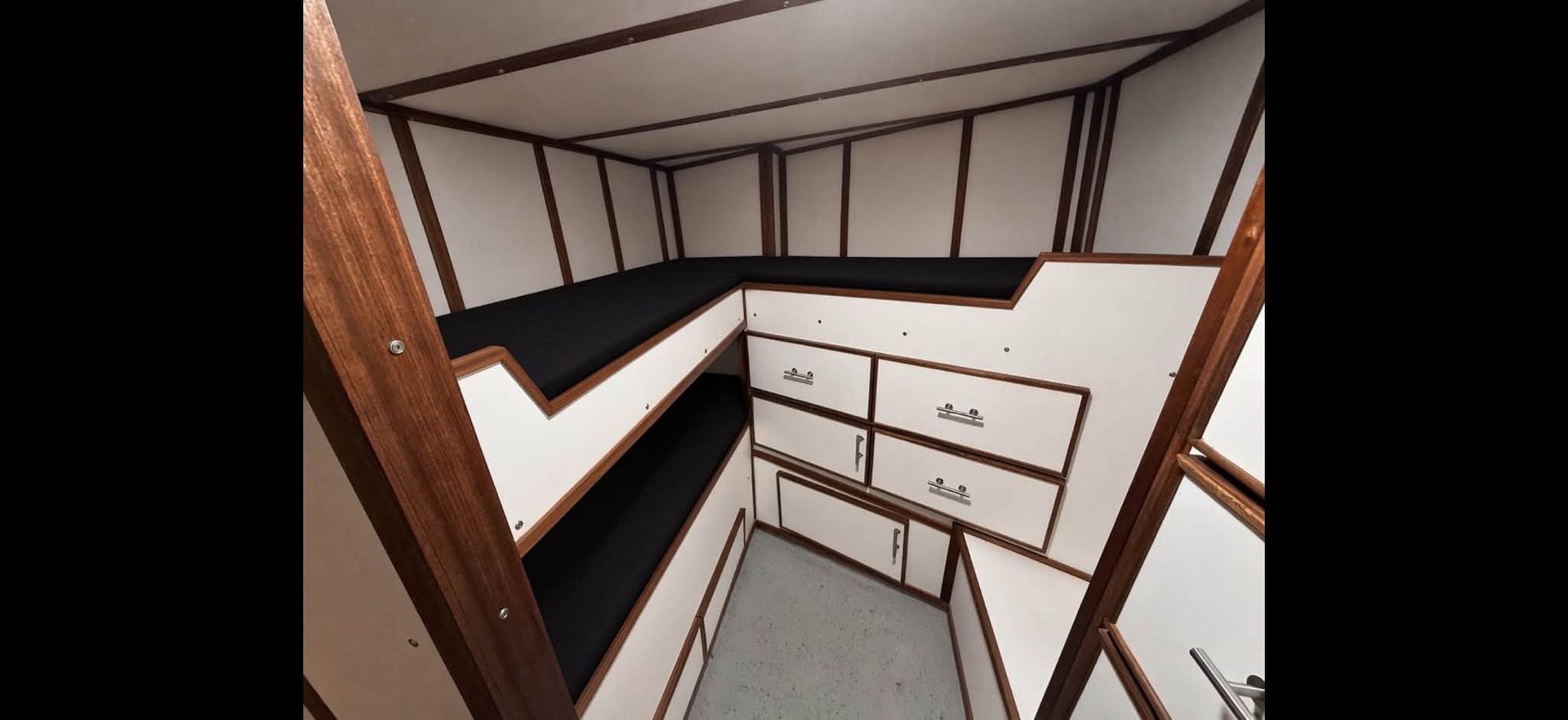 Stylized interior hallway with white walls, dark trim, and drawers along a corner, viewed from above.