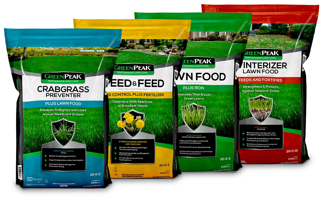 Four bags of lawn care products lined up: crabgrass, weed feed, lawn food, and winterizer.