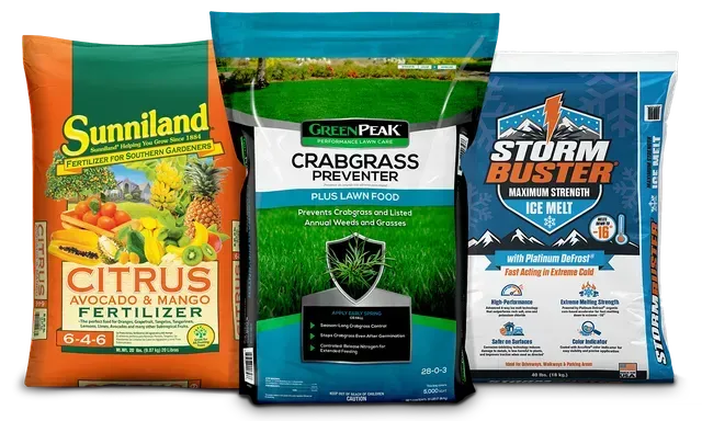 Three lawn care products in colorful bags: citrus fertilizer, crabgrass preventer, and storm blaster ice melt.