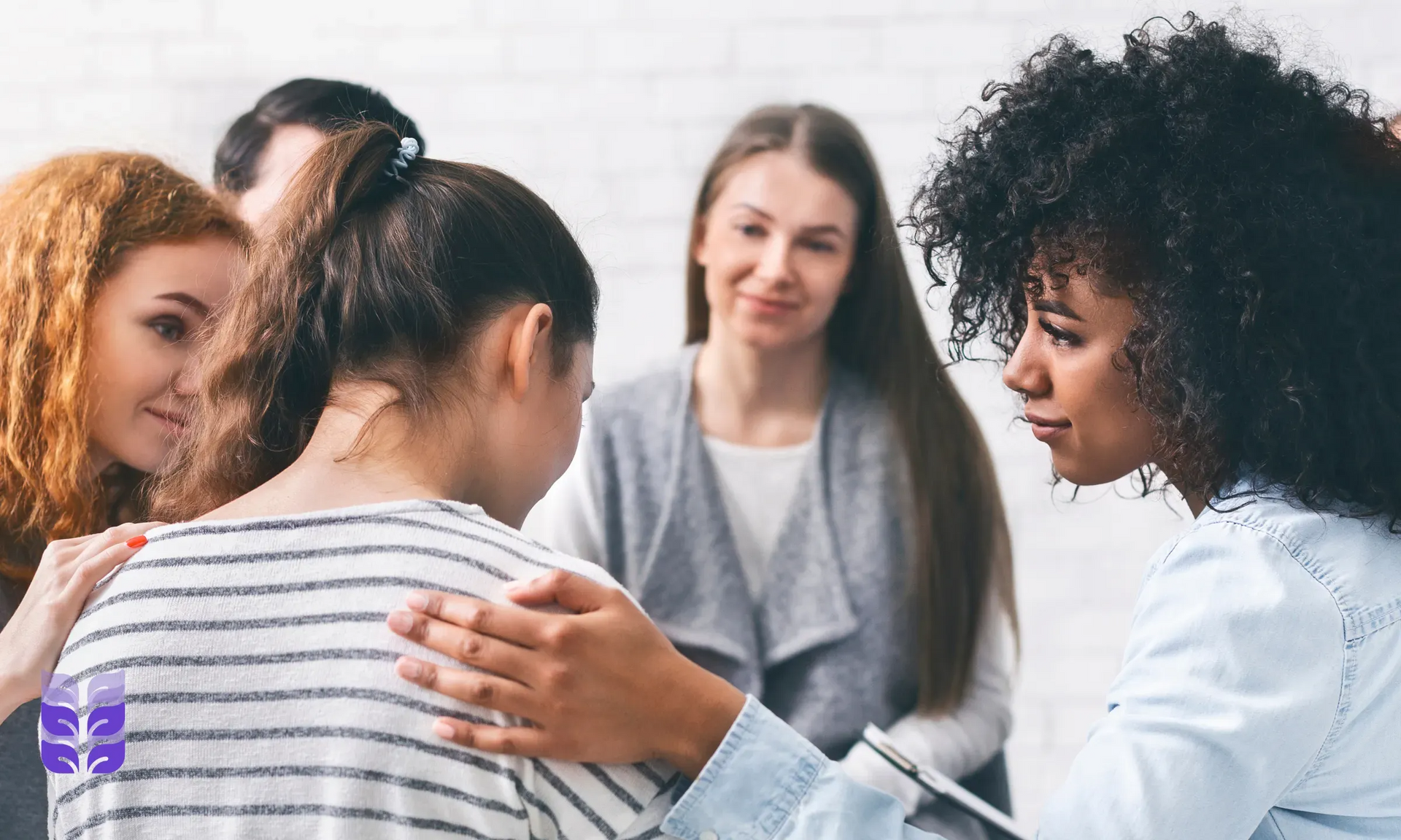 Small group in a counseling circle, one woman speaking while others listen supportively