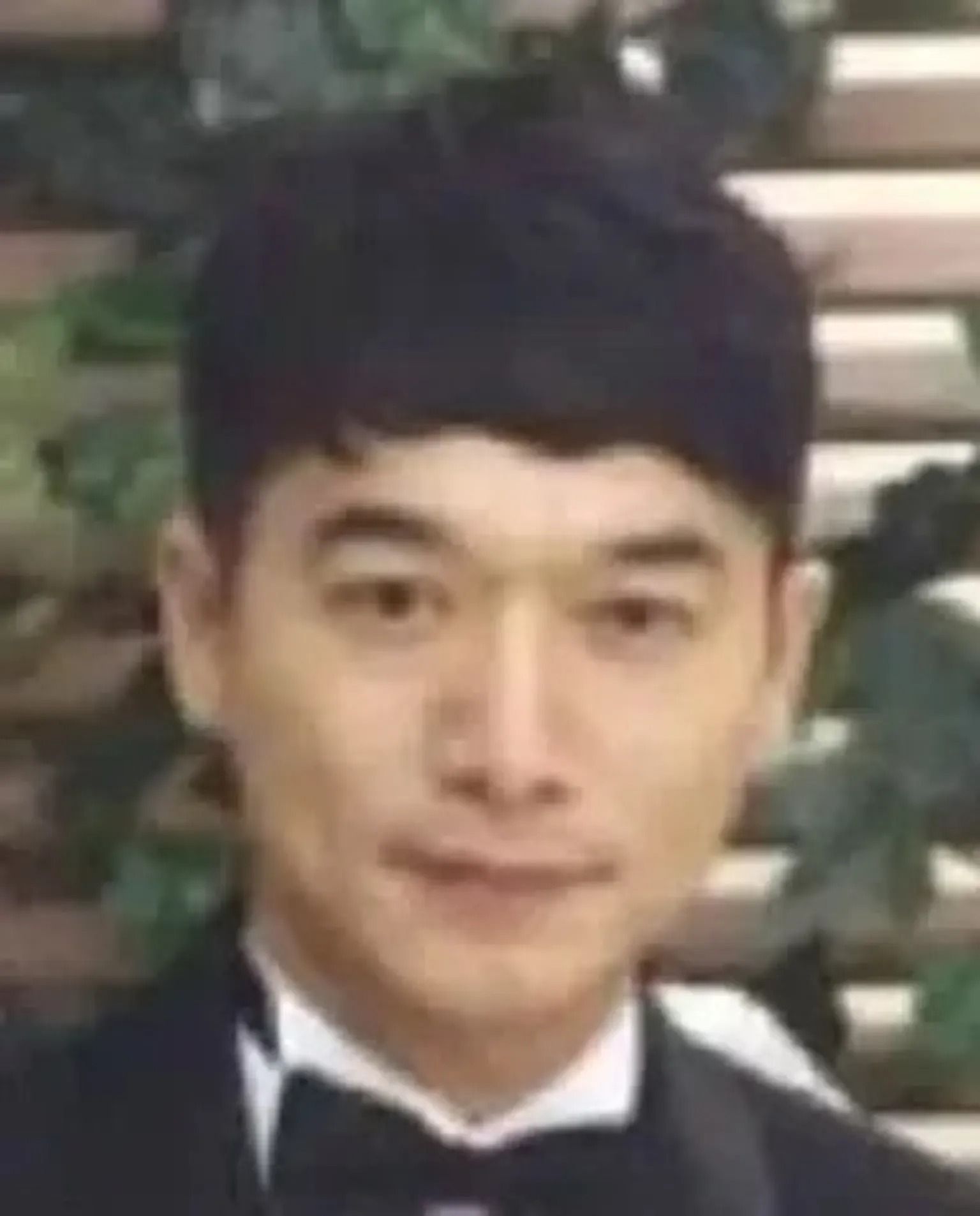 Portrait of a person in a black tuxedo and bow tie, facing forward with a slight smile.