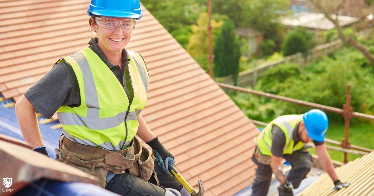 Two construction workers are working on the roof of a house. Two construction workers are working on the roof of a house.