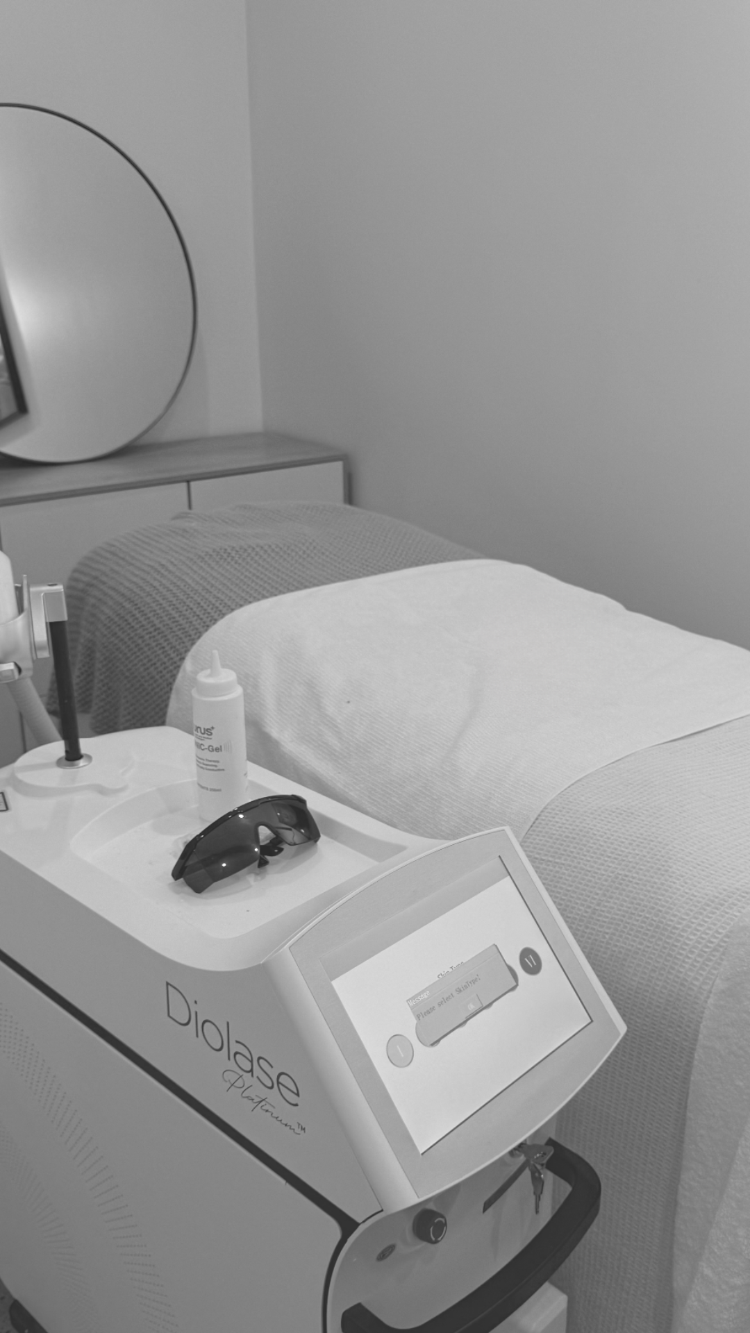 Clinic treatment bed with a handheld device and machine console — Vanity Skin and Beauty Forster in Forster, NSW