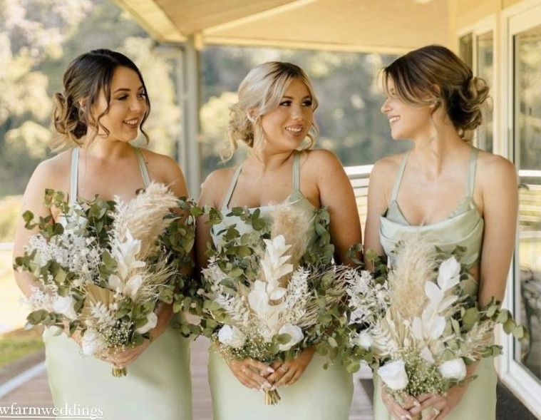 Three bridesmaids are standing next to each other on a porch holding bouquets of flowers. — Vanity Skin and Beauty Forster in Forster, NSW