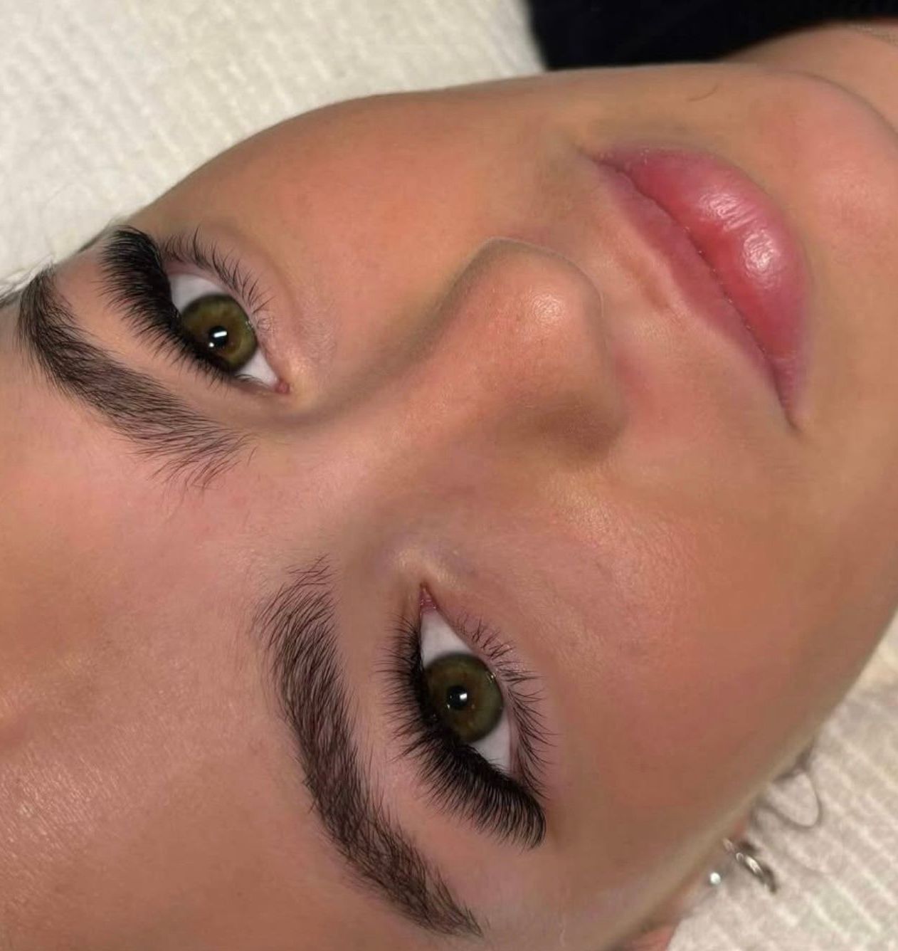 A close up of a woman 's face with green eyes and a pink lip. — Vanity Skin and Beauty Forster in Taree, NSW