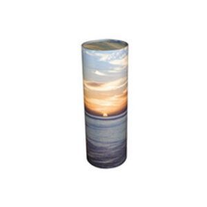 Tall cylindrical candle with a sunset beach scene print in blue, orange, and gray.