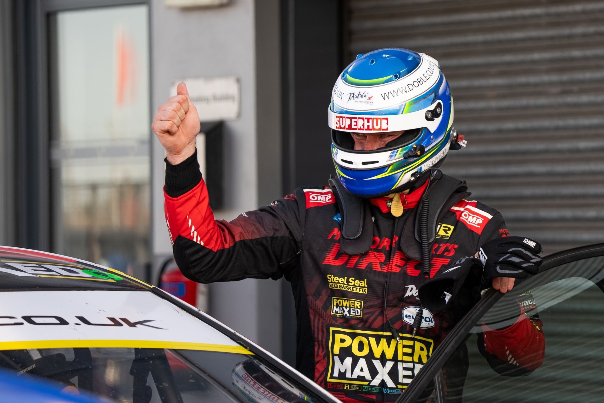 Mikey Doble giving thumbs up after getting out of Vauxhall Astra at Donington Park BTCC 2025