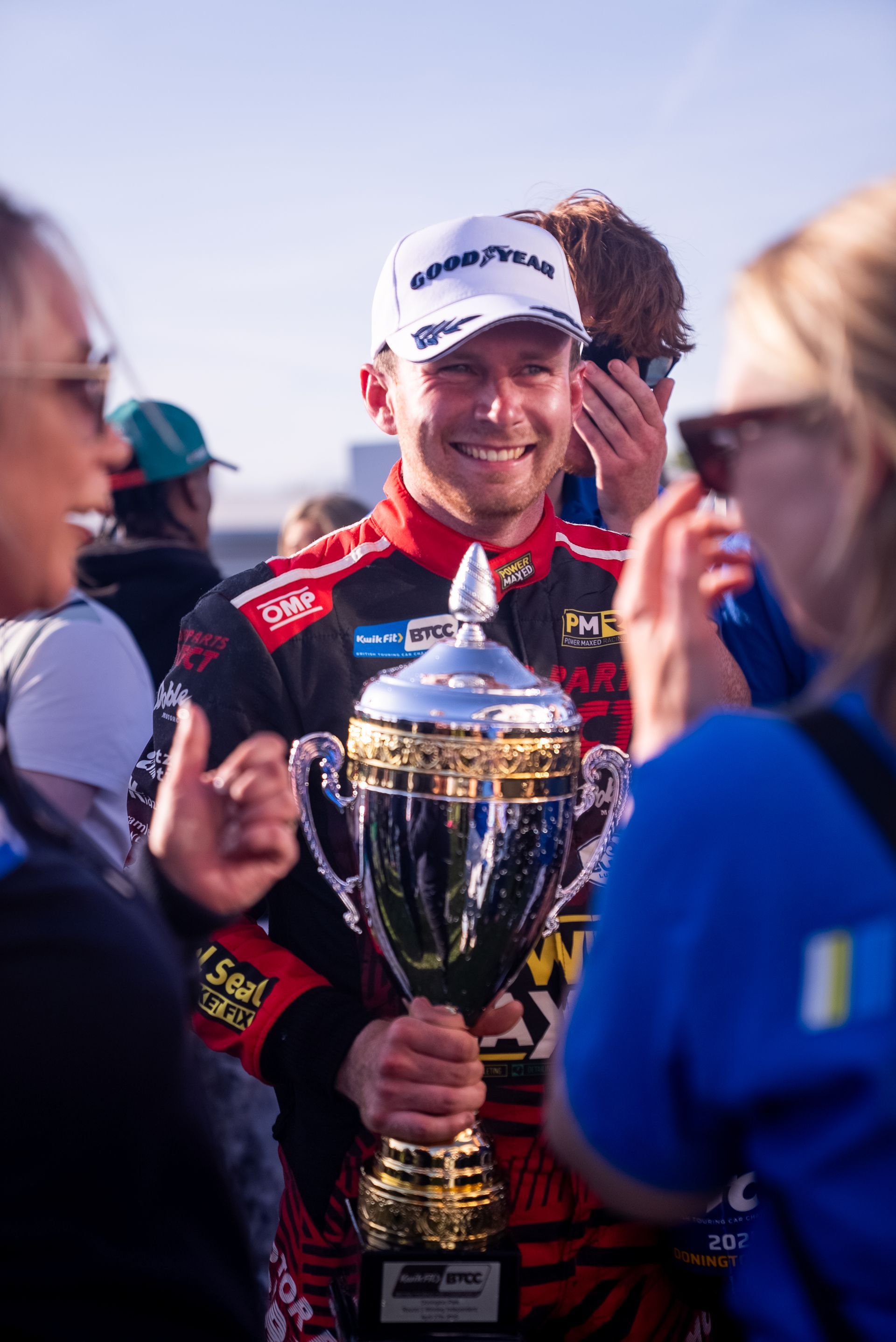 Mikey Doble celebrating with BTCC 2025 Independent Tophy and Champagne at Donington Park