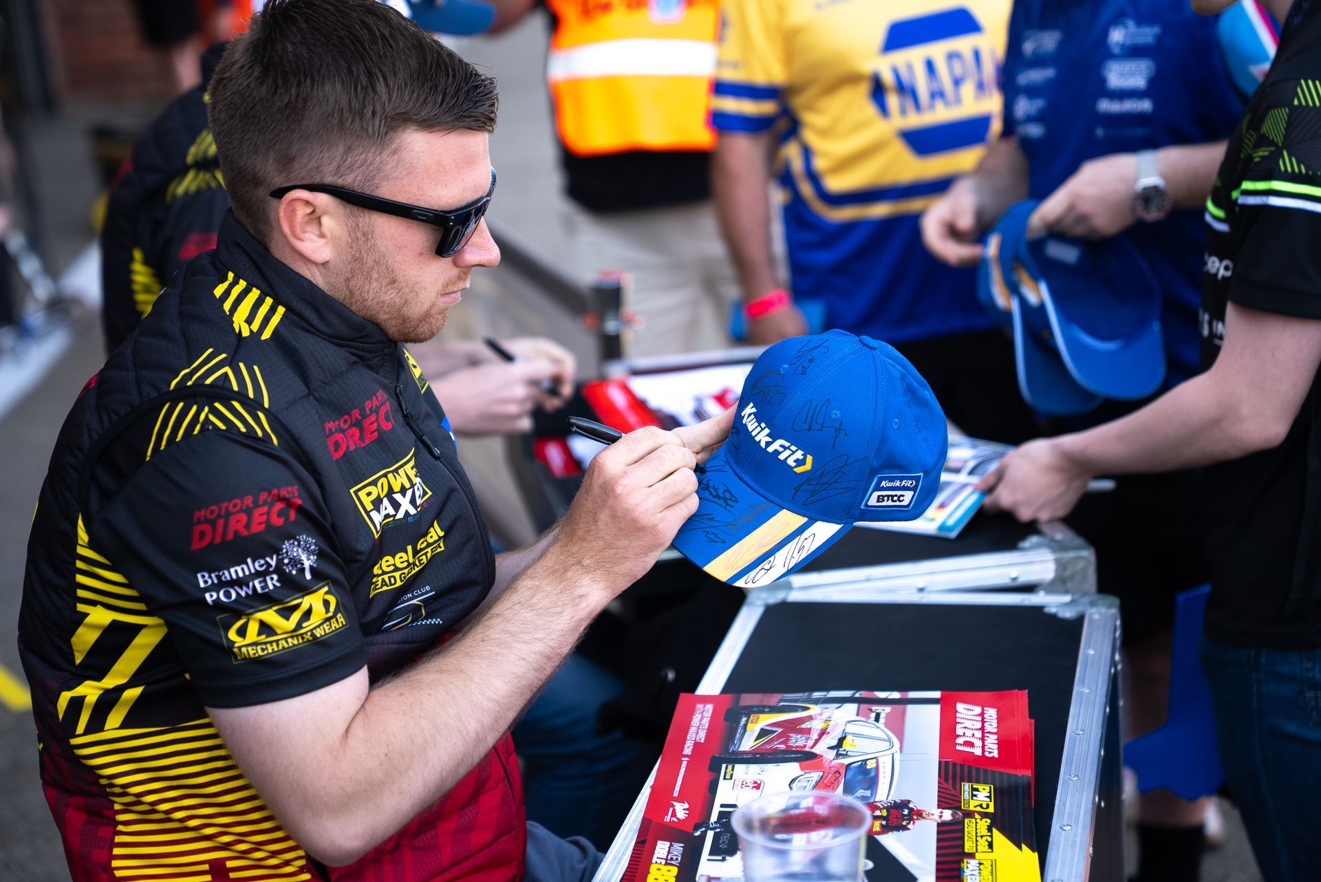 Mikey Doble signing Kwikfit hat at Brands Hatch 2025 BTCC