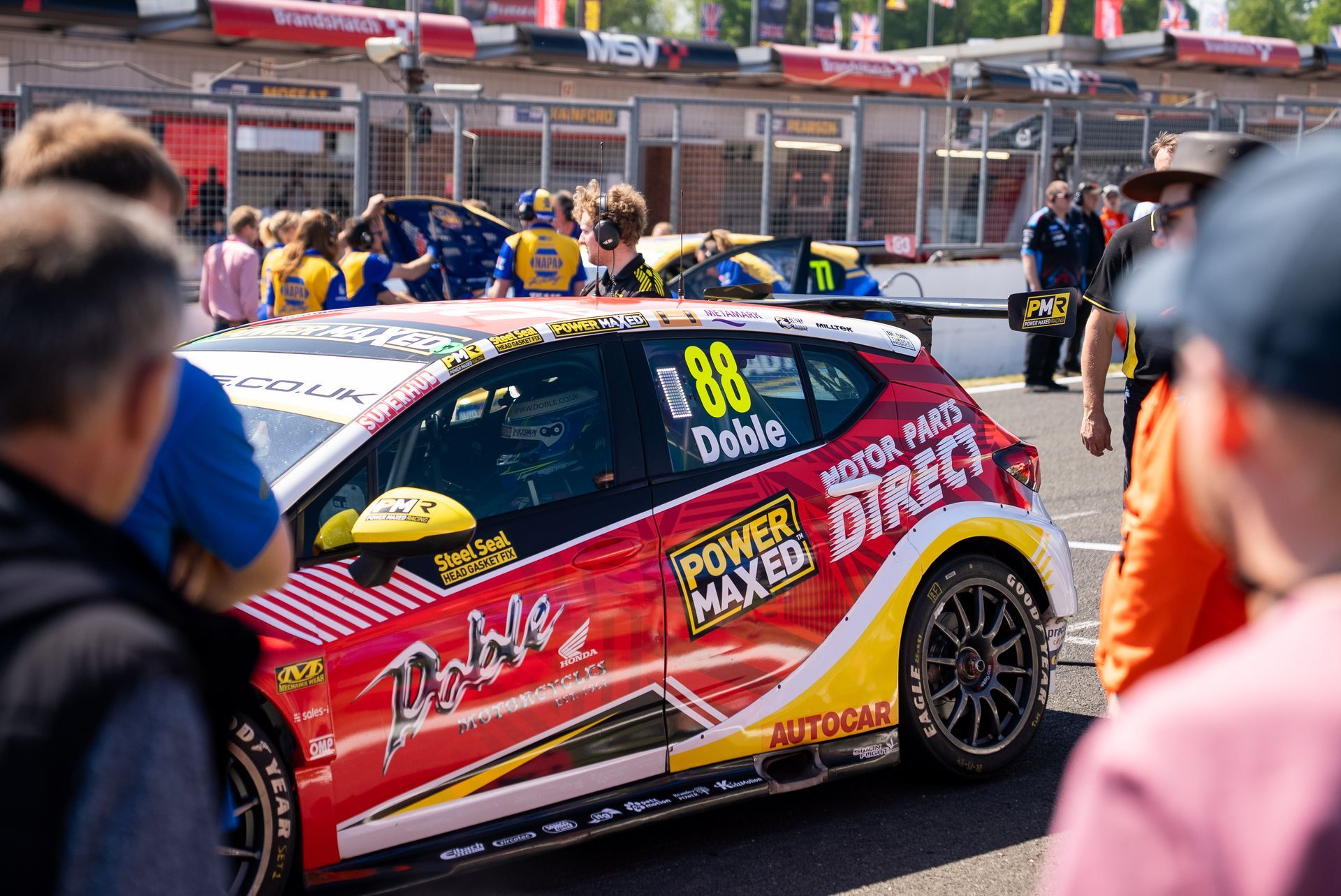 Spectators looking at Mikey Doble's Vauxhall Astra on the grid at BTCC 2025 Brands Hatch Indy