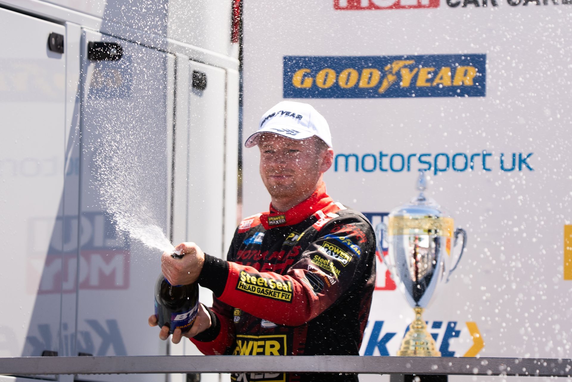 Mikey Doble spraying champagne after winning the independent trophy at Brands Hatch Indy in BTCC 2025