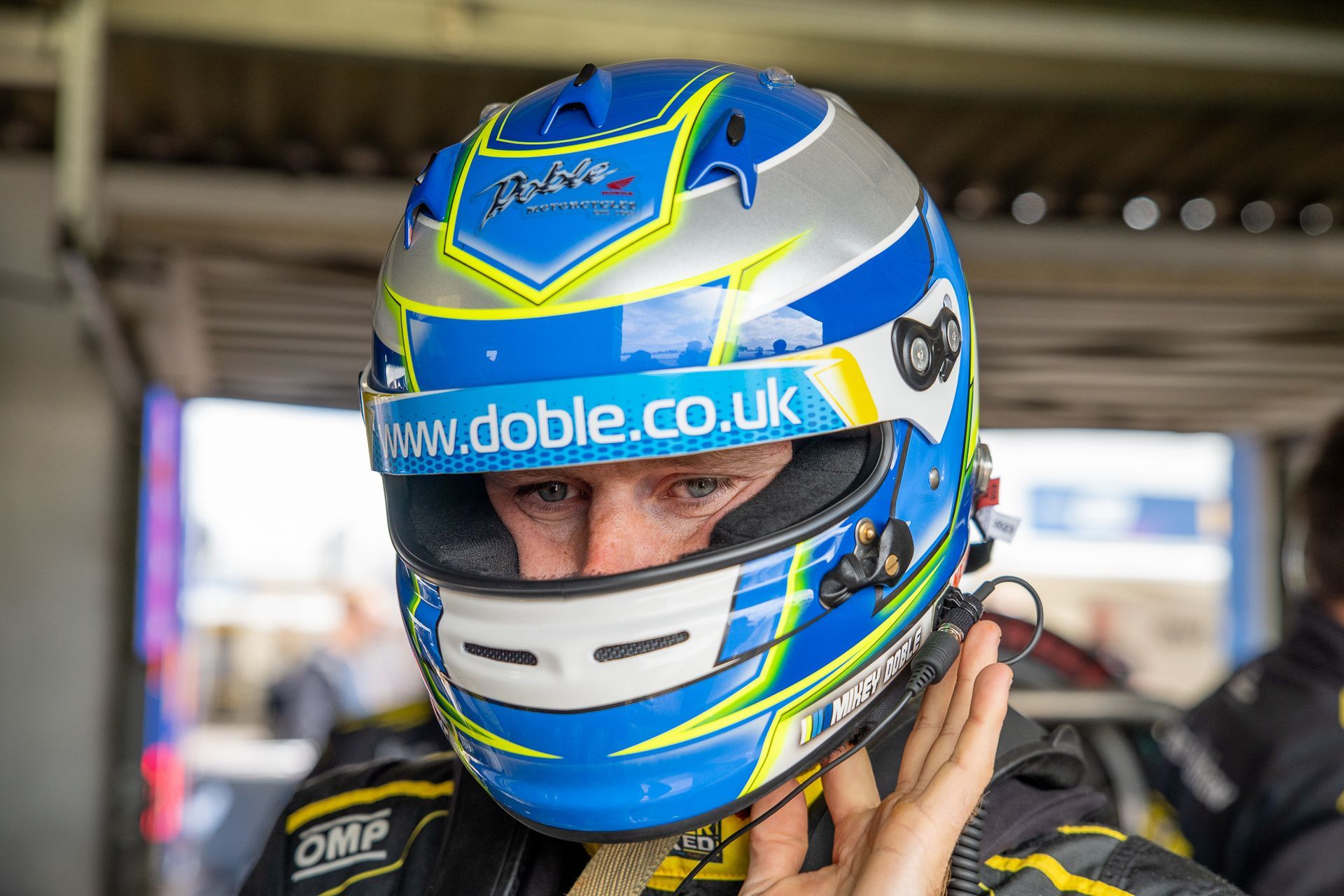 A man wearing a helmet with the website www.doble.co.uk on it