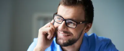 Man smiling while calling