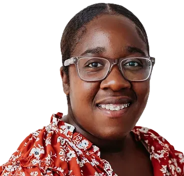 A woman wearing glasses and a red floral shirt is smiling.