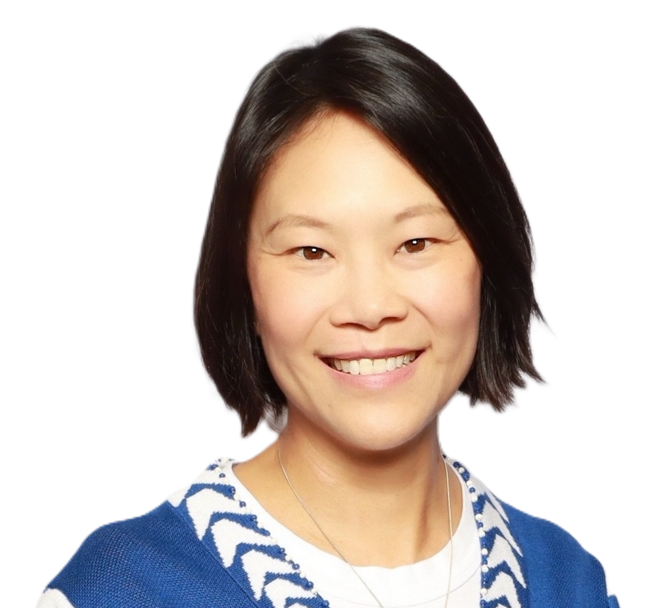A woman wearing a pink shirt and necklace smiles for the camera
